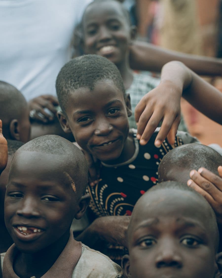 A group of children smiling together outdoors
